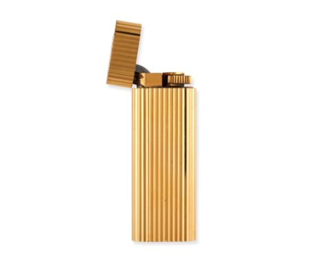 NO RESERVE - LE MUST DE CARTIER, A LIGHTER in gold plate, the lighter decorated with fluted detailing, signed Cartier and num