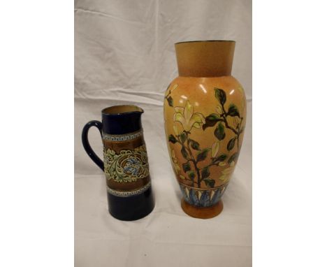 A Doulton pottery tapered jug with raised leaf decoration and a Linthorpe pottery tapered vase with floral decoration on brow