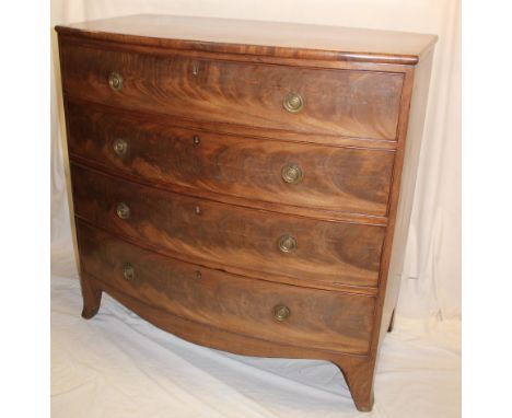 A 19th century mahogany chest of four long drawers with brass ring handles on bracket feet