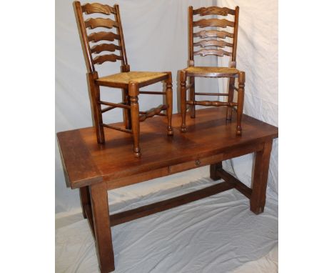 A polished oak country-style rectangular dining table with a small frieze drawer on square legs 63" x 31" together with a set