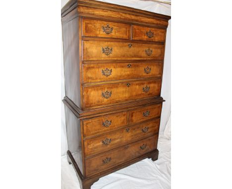 An impressive 1920's inlaid walnut chest on chest by Waring &amp; Gillow Ltd., the base with two short and two long drawers w