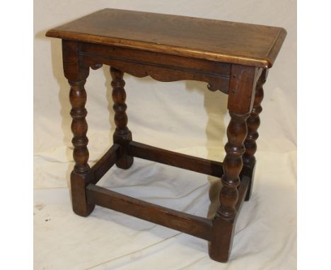 An oak rectangular joint-style stool on bobbin turned supports