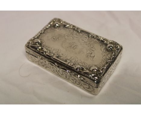 A 19th Century silver rectangular snuff box with engraved and raised scroll decoration, Birmingham marks, 3 1/2" long