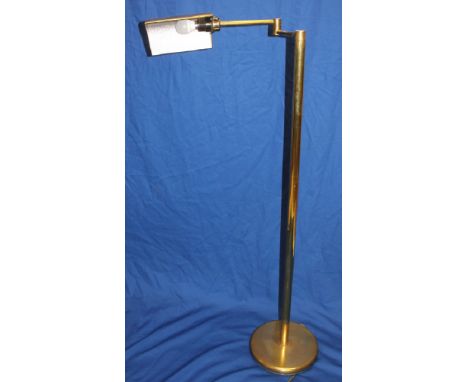 A vintage brass articulated floor reading lamp with adjustable arm on circular base