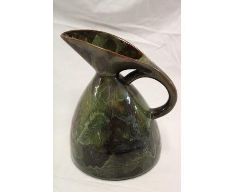 A Linthorpe pottery Art Deco-style tapered jug in the manner of Christopher Dresser with green and brown glazed decoration, 8