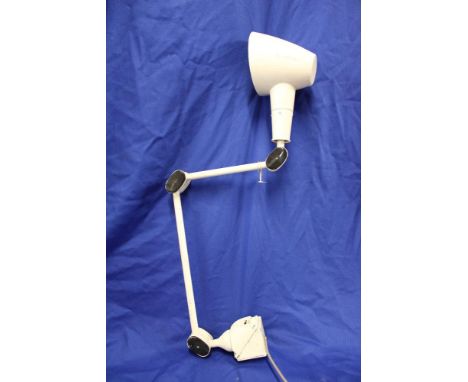 A vintage painted metal adjustable machinist's lamp with folding arm
