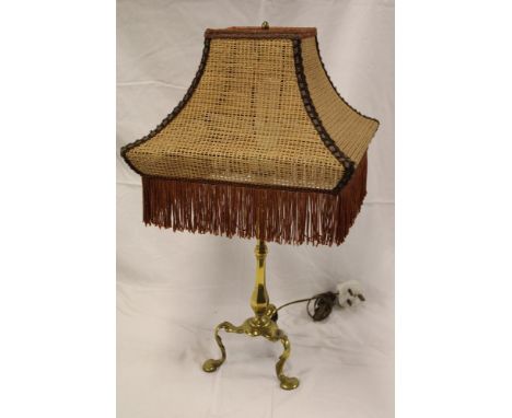 A brass Pullman carriage table lamp with octagonal tapered stem with tripod scroll base supporting a fabric shade