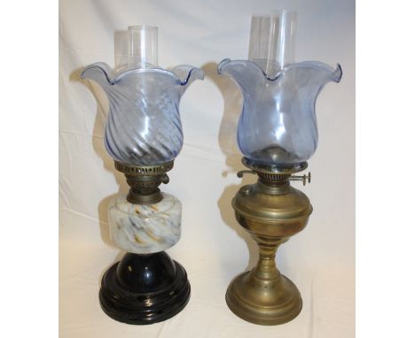 A Victorian oil lamp with mottled glass reservoir and blue tinted glass shade and one other brass oil lamp with similar blue-