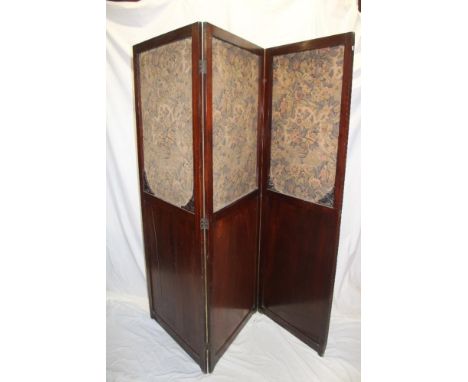 A late 19th/early 20th century mahogany rectangular three fold dressing screen with tapestry panels