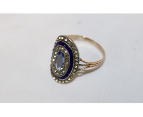 An early 19th century gold and silver dress ring with enamelled centre set aquamarine (damaged)