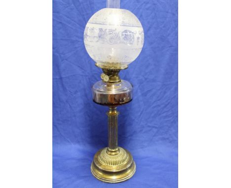 A Victorian brass oil lamp with clear glass reservoir, fluted column and circular base with etched glass shade