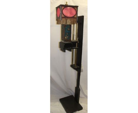 An unusual painted wood Chinese-style standard lamp with painted metal figure decorated centre and hanging shade