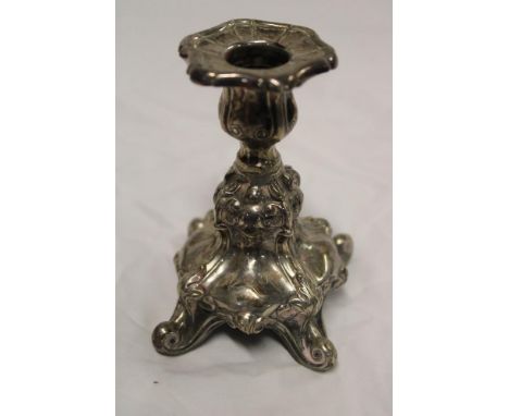 A sterling silver candlestick with scroll tapered stem and scroll legs, 4 1/2" high