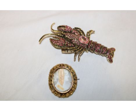A pinchbeck oval brooch mounted with a female portrait cameo and a decorative lobster brooch (2)