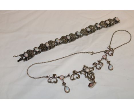 An ornate silver bracelet mounted with opal and marcasite and a similar pendant necklace