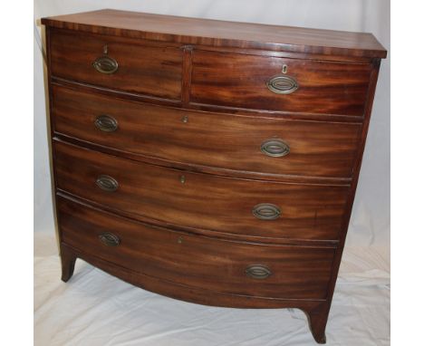 A mid-Victorian mahogany bow-front chest of two short and three long drawers with brass ring handles on bracket feet