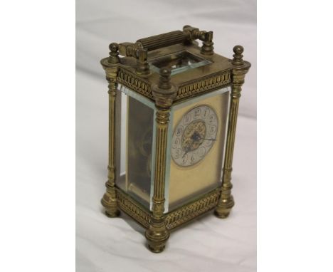 A good quality carriage clock with silvered circular dial in brass rectangular traditional case with fluted columns