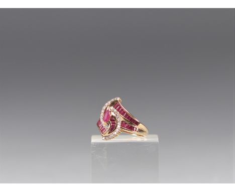 Gold Ruby and Diamond Ring. The center of this ring is composed of rubies in a non-traditional movement, and surrounded by di