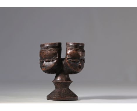 This magnificent Kuba palm wine cup is a rare and precious piece. It is adorned with two stylised heads that act as communica