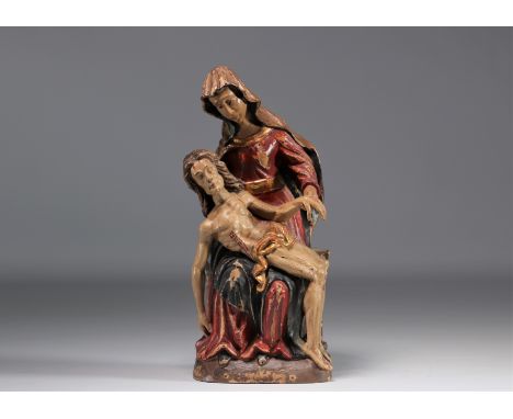 Pieta" sculpture in polychrome wood. It depicts the biblical theme of the "sorrowful Virgin Mary", holding the body of Christ