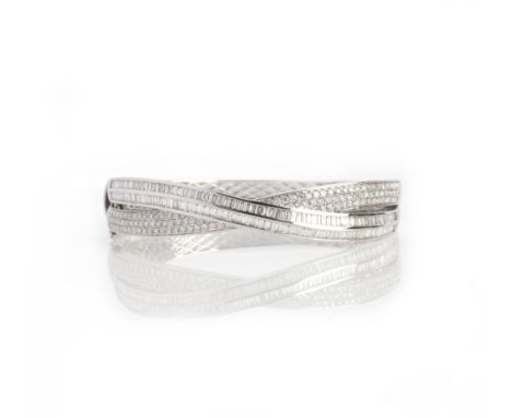 A diamond bangle, the hinged bangle of crossover design, the front section pavé-set with brilliant-cut diamonds and channel-s