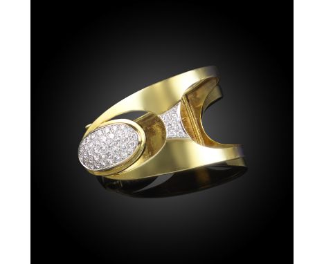 A diamond-set gold bangle, 1960s, designed as an openwork hinged cuff, the oval bombé panel pavé-set with brilliant-cut diamo