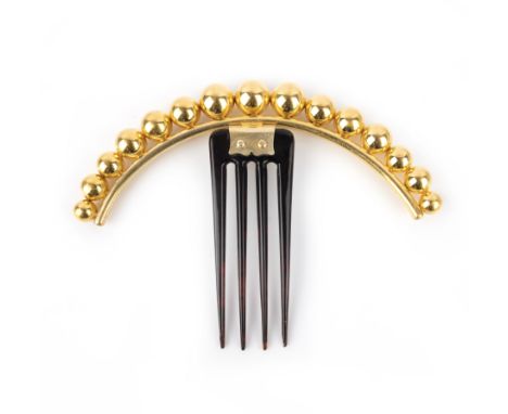 λ A gilt metal and tortoiseshell hair orament, mid 19th century, the gilt upper section designed as an arc of graduated spher