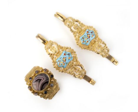 A pair of enamel bracelets and a hardstone bracelet, mid 19th century, comprising: a pair of cuff bracelets, composed of gilt