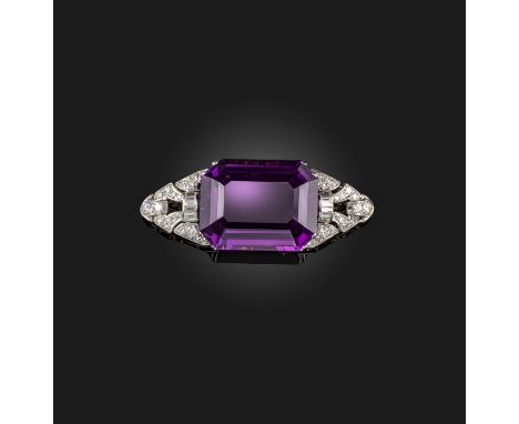 A mid 20th century amethyst and diamond brooch, the large emerald-cut amethyst set within a pierced lozenge-shaped diamond-se
