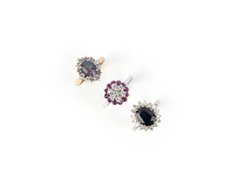 A collection of three rings, comprising: a ring designed as a cluster of brilliant-cut diamonds and circular-cut rubies, moun