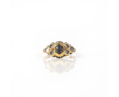 A 17th century rock crystal and enamel ring, set with seven graduated rose-cut rock crystals in cut-down collets with black e