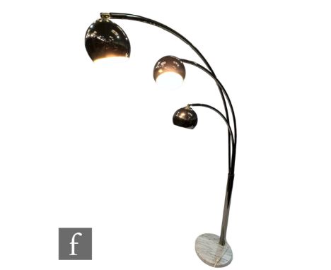In the manner of Guzzini - An Italian three Arc floor lamp, the central tubular stem with three arched branches, extending to