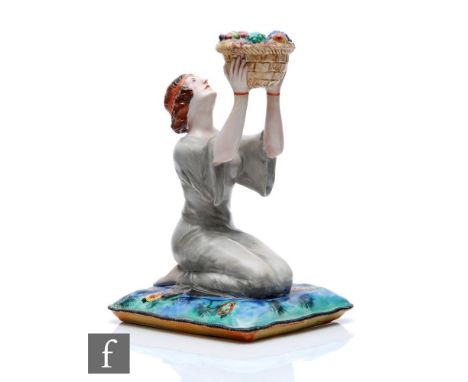 Clarice Cliff - A.J.Wilkinson - A figural candlestick modelled as a kneeling lady in flowing gown holding aloft a basket of f