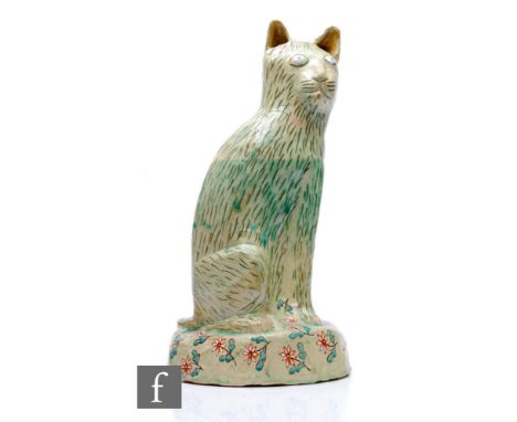 Hylton Nel - A large hand crafted studio pottery figure of a large seated cat with upright ears, decorated with a tonal mottl