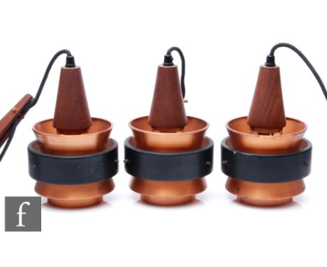 In the manner of Jorn Utzon - A set of three 1960s Danish pendant wall lights, the copper and black banded shade, with teak w