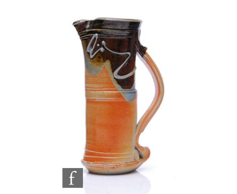 Barry Huggett - A contemporary studio stoneware jug of cylinder form with pulled ribbed handle, decorated with relief abstrac