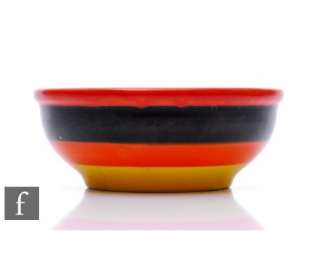 Clarice Cliff - Banded - A small heavy rimmed bowl hand painted with red, black, orange and yellow banding, the base over ena