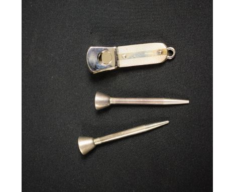 A silver mounted cigar cutter, Harrison Brothers & Howson Ltd, London 2007;  a pair of silver golf tees, stamped sterling (3)