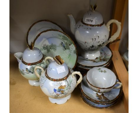 A Japanese eggshell teapot, sucrier and cover, milk jug, butterfly finials, similar side plates, a cup and saucer