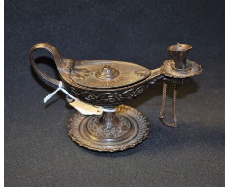 A 19th century Grand Tour dark patinated chamberstick, as a Roman lamp, hinged cover, scroll handle, dished base cast with a 