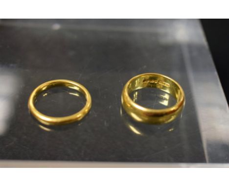 A 22ct gold curtain hoop wedding band, size K, another slender, size J, 10.1g (2)