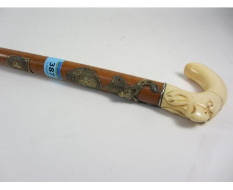 Swiss walking stick, ivory handle carved with bird's head, badges on the malacca shaft for Switzerland, Grindelwald and Inter