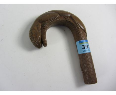 Carved wood walking stick handle in the form of a lizard with glass eyes
