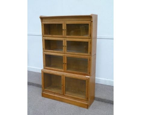 Early 20th century light oak stacking library bookcase, enclosed by eight glazed doors, W90cm x H142cm