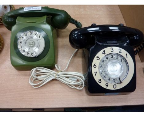 Two vintage plastic rotary dial telephones (black, green)