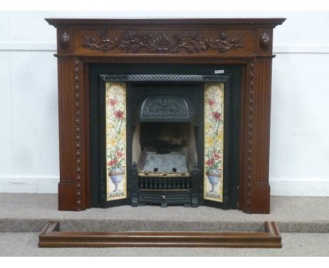 Victorian style gas fire place fitted with decorative tiles, with fitted mahogany fire surround and oak fender