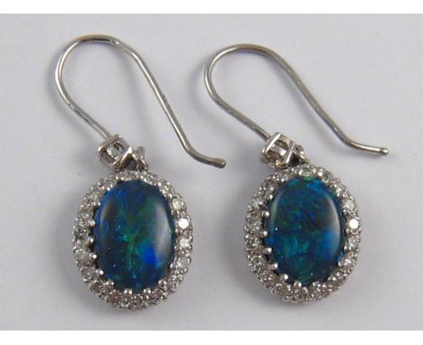 A pair of opal and diamond earrings , opals approx 9 x 7mm, 4.1 gms.