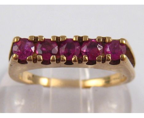 A 9 carat gold five stone ruby ring, size N, 2.8 gms.