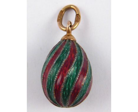 A Russian gold miniature Easter egg with cloisonne enamelled swirl stripes, the suspension loop stamped C K and St. Petersbur