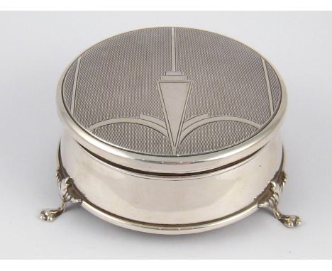 A silver velvet lined round trinket box on three feet , the lid engine turned. Birmingham, 1950 8.5cm. diameter. 